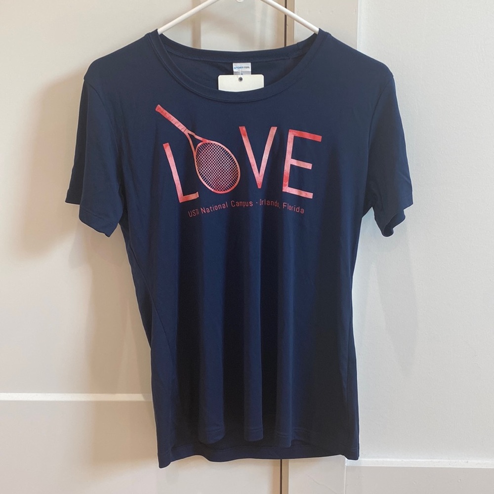 This is a brand new T-shirt from USTA national campus. It is a navy color.